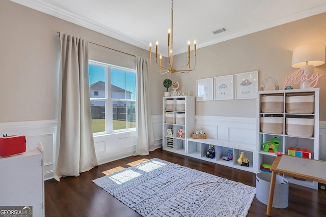 rec room with wood finished floors, a notable chandelier, visible vents, and a wainscoted wall