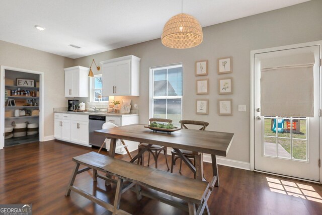 dining space with dark wood-style flooring, baseboards, and visible vents