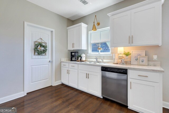 kitchen featuring dark wood finished floors, white cabinets, dishwasher, a sink, and baseboards
