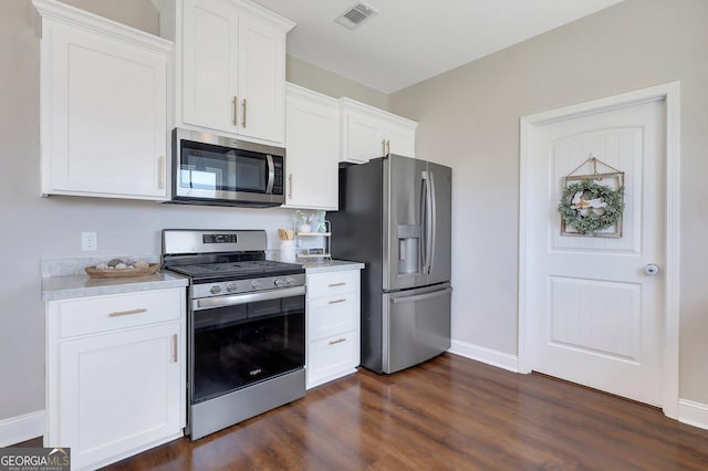 kitchen with baseboards, dark wood-style floors, light countertops, visible vents, and appliances with stainless steel finishes