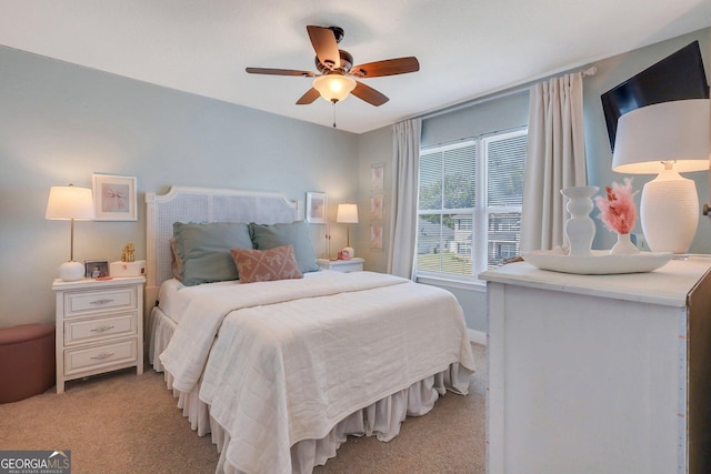 bedroom with light carpet, baseboards, and a ceiling fan