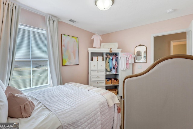 bedroom featuring multiple windows and visible vents