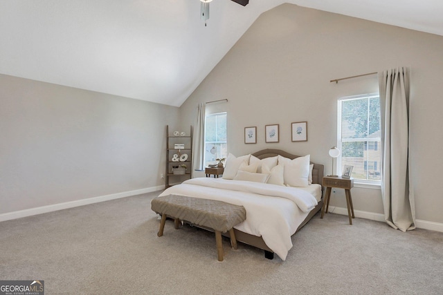 bedroom featuring baseboards, high vaulted ceiling, light colored carpet, and a ceiling fan