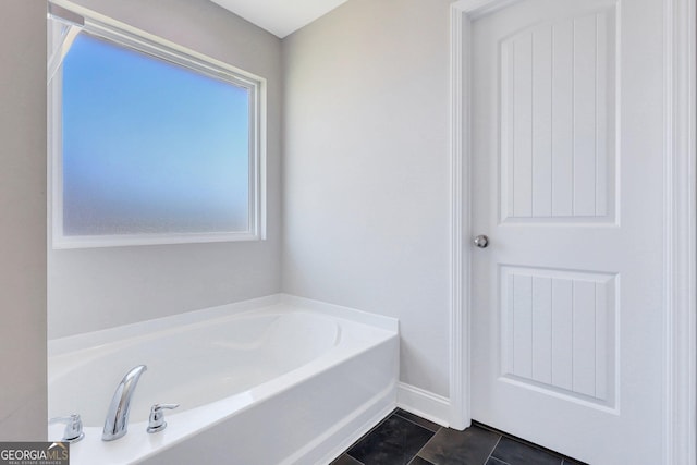 bathroom featuring a bath and tile patterned floors