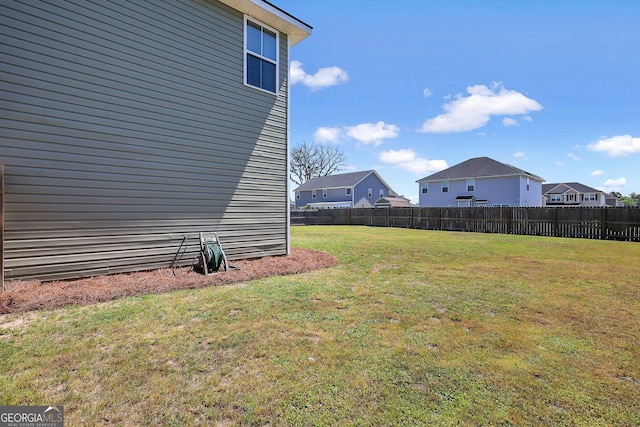 view of yard with a residential view and fence