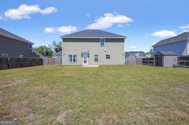back of house with a shed, a yard, a fenced backyard, and an outbuilding