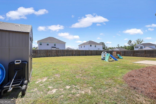 view of yard with a fenced backyard and a playground