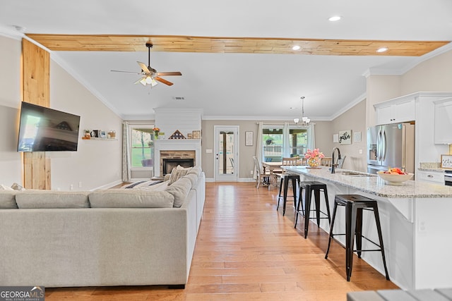 75 Flagstone Dr, Newnan, GA 30263 - living area with a ceiling fan, light wood-style flooring, recessed lighting, a fireplace, and ornamental molding