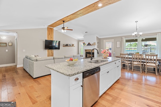 75 Flagstone Dr, Newnan, GA 30263 - kitchen with stainless steel dishwasher, a ceiling fan, a fireplace, light wood-style flooring, and an island with sink