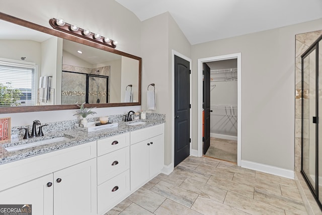 75 Flagstone Dr, Newnan, GA 30263 - bathroom with a stall shower, double vanity, lofted ceiling, and a spacious closet