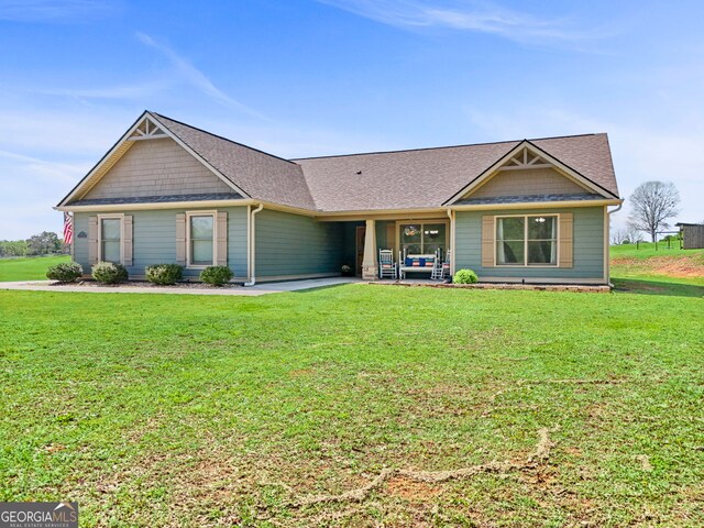 75 Flagstone Dr, Newnan, GA 30263 - craftsman-style home featuring a front yard, roof with shingles, and a patio area
