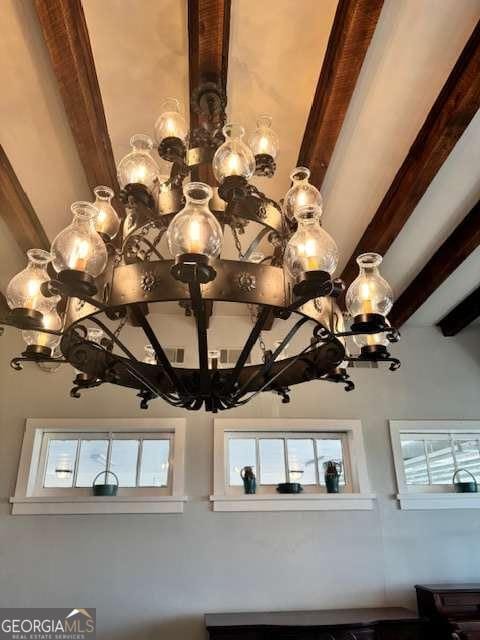 interior details with a chandelier and beamed ceiling