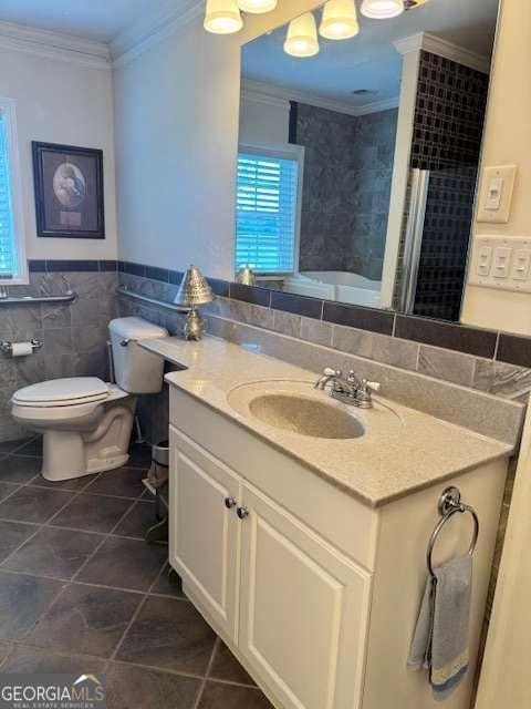 full bath with vanity, ornamental molding, tile patterned flooring, toilet, and tile walls
