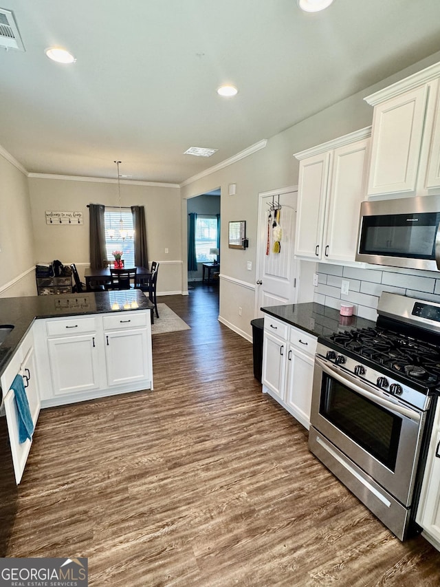 141 Macalester Dr, Newnan, GA 30265 - kitchen featuring stainless steel appliances, dark wood-style floors, ornamental molding, white cabinetry, and backsplash