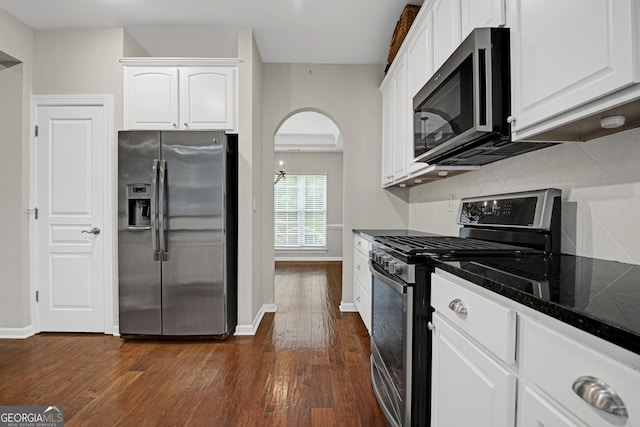 kitchen featuring stainless steel appliances, dark wood-style floors, and white cabinetry