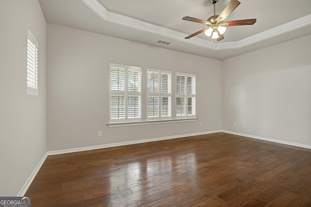 empty room featuring a wealth of natural light, crown molding, and a tray ceiling