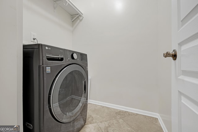 laundry area with washer / dryer, light tile patterned floors, baseboards, and laundry area