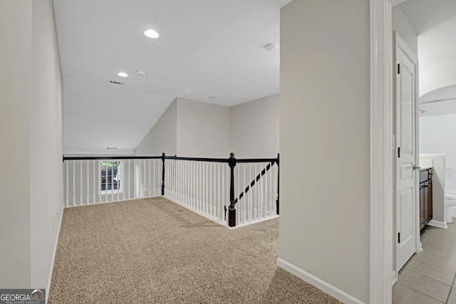 corridor featuring recessed lighting, visible vents, baseboards, and light carpet