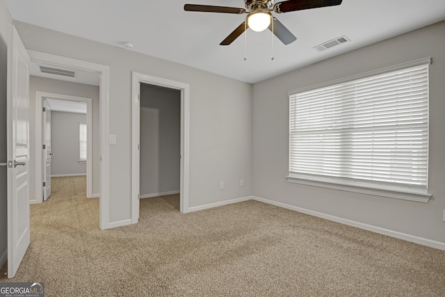 unfurnished bedroom with baseboards, visible vents, and carpet