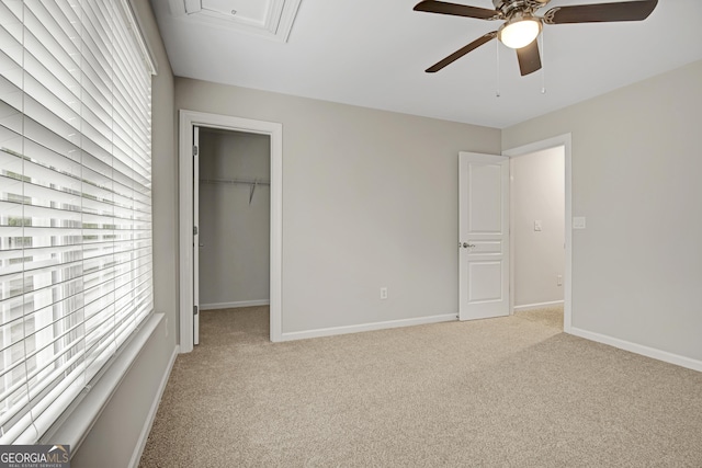 unfurnished bedroom with light colored carpet, baseboards, multiple windows, and a closet
