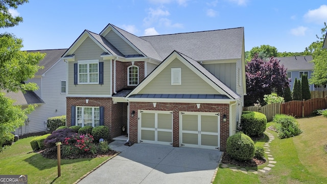 view of front of home with roof with shingles, a front lawn, driveway, fence, and brick siding