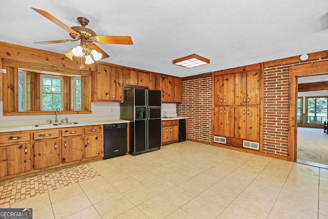 482 E Lake Rd, Mcdonough, GA 30252 - kitchen featuring light countertops, visible vents, a sink, black appliances, and brown cabinetry