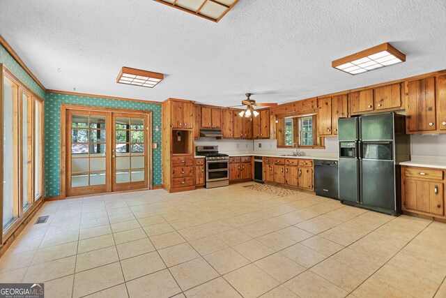 482 E Lake Rd, Mcdonough, GA 30252 - kitchen featuring wallpapered walls, a textured ceiling, brown cabinets, and black appliances