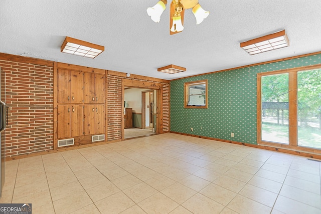 482 E Lake Rd, Mcdonough, GA 30252 - spare room with a textured ceiling, visible vents, a ceiling fan, and light tile patterned floors