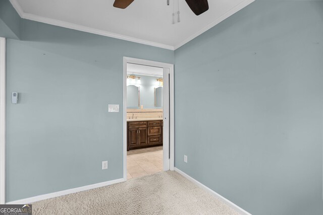 482 E Lake Rd, Mcdonough, GA 30252 - unfurnished bedroom with connected bathroom, ceiling fan, light colored carpet, baseboards, and ornamental molding