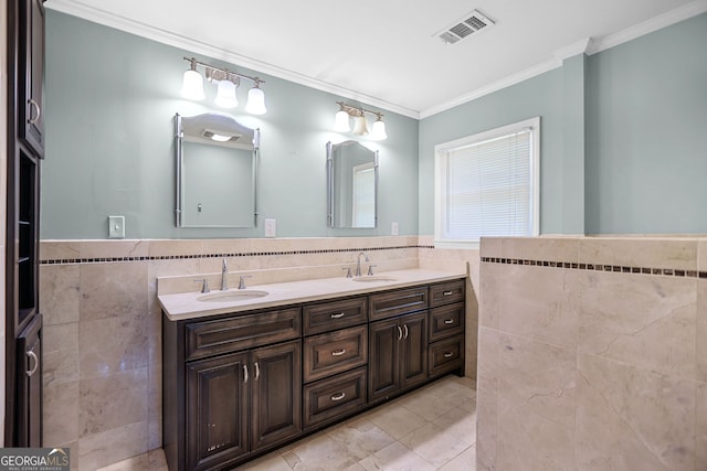 482 E Lake Rd, Mcdonough, GA 30252 - bathroom featuring a sink, tile walls, double vanity, ornamental molding, and visible vents