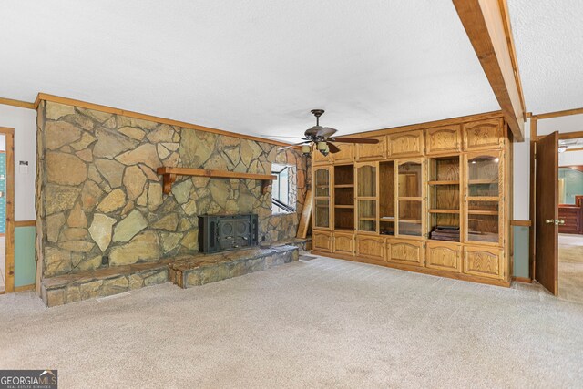 482 E Lake Rd, Mcdonough, GA 30252 - unfurnished living room featuring carpet, a wood stove, crown molding, and ceiling fan