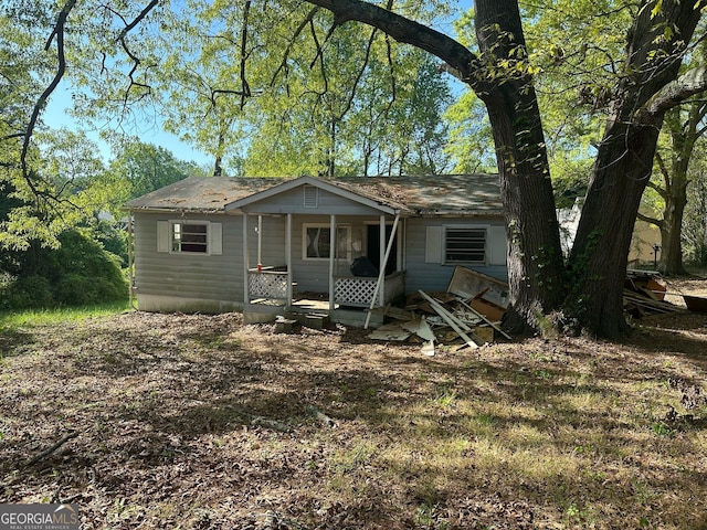 1099 Warren Dr, Riverdale, GA 30296 - bungalow featuring a shingled roof and covered porch