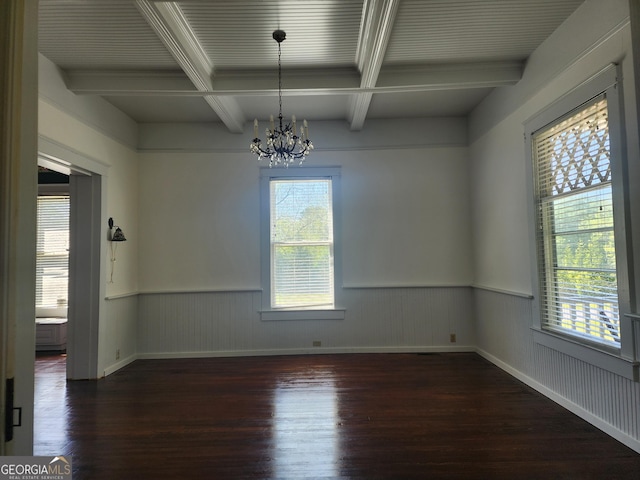 unfurnished dining area with beamed ceiling, wood finished floors, a notable chandelier, and plenty of natural light