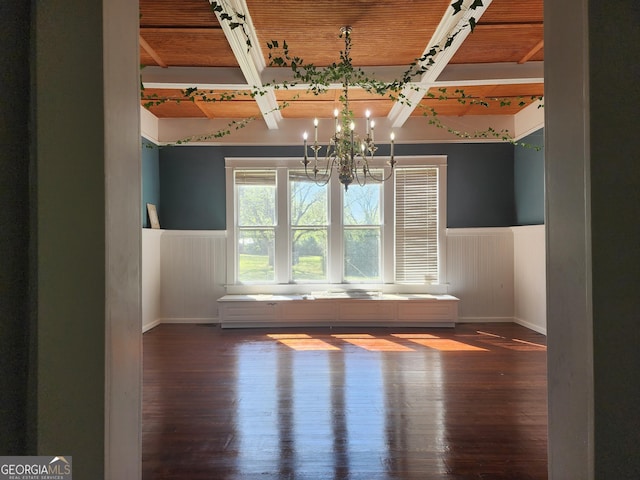 unfurnished room with wainscoting, baseboards, wood finished floors, and a chandelier
