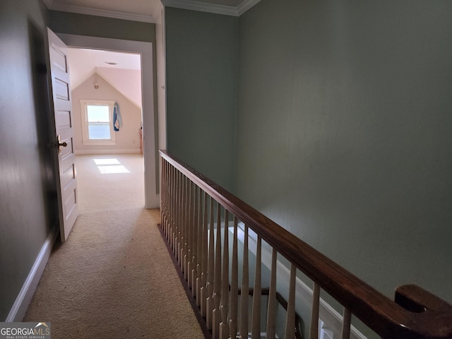hall featuring baseboards, ornamental molding, light carpet, an upstairs landing, and lofted ceiling