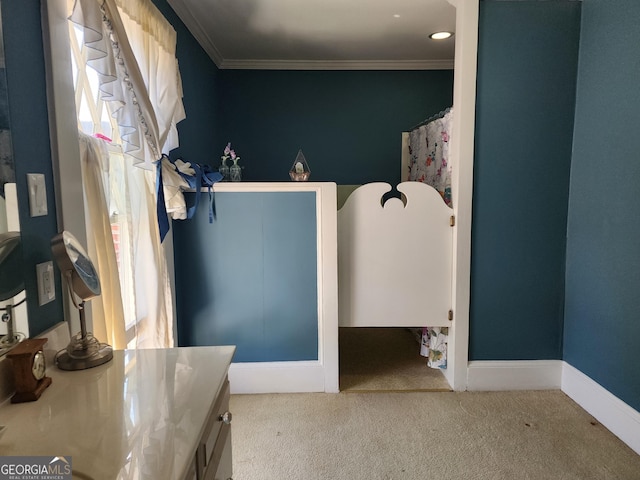 bathroom featuring vanity, crown molding, and baseboards