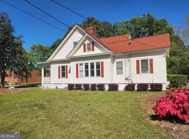 view of front of property featuring a porch, crawl space, a chimney, and a front yard