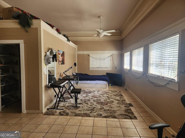 bedroom featuring a ceiling fan, baseboards, crown molding, and light tile patterned flooring