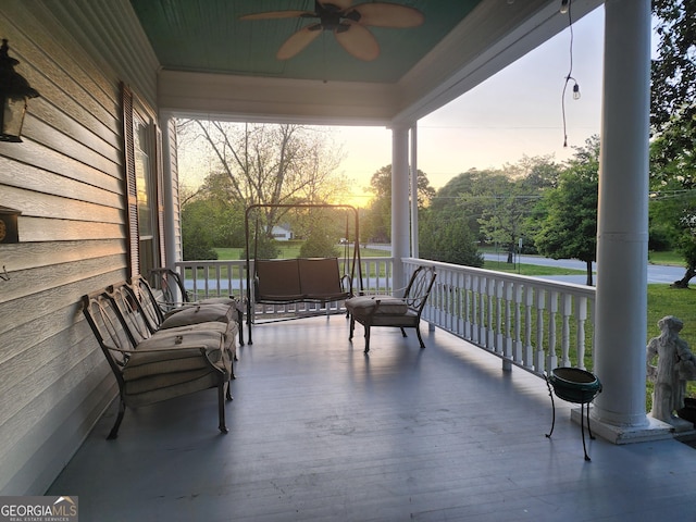 deck with a porch and ceiling fan