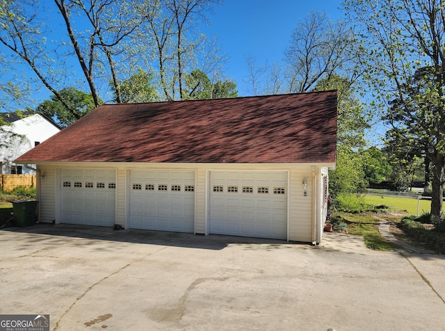 detached garage featuring fence