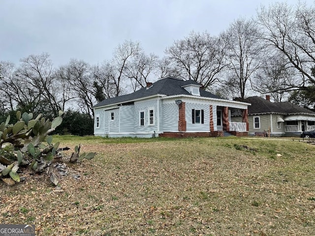 view of front facade featuring a front lawn and a chimney