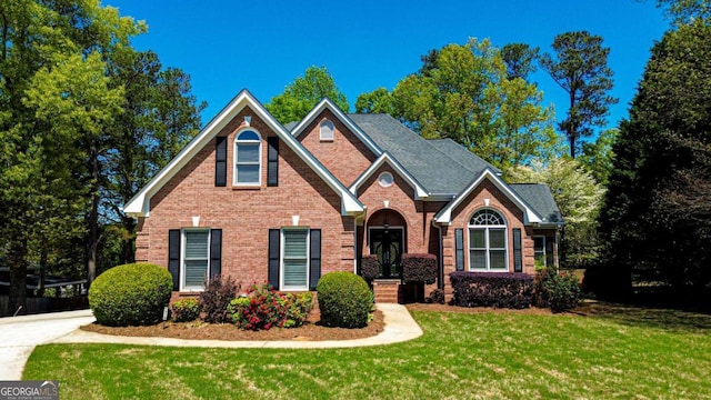 2319 Lochinver Ln SW, Conyers, GA 30094 - traditional home featuring a front yard and brick siding