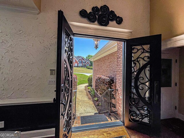 2319 Lochinver Ln SW, Conyers, GA 30094 - entryway featuring a chandelier, ornamental molding, and a textured wall