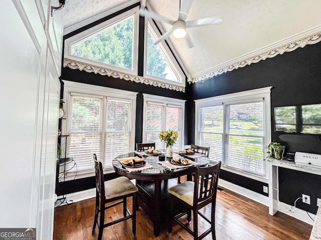 2319 Lochinver Ln SW, Conyers, GA 30094 - dining area with wood finished floors, a ceiling fan, high vaulted ceiling, and baseboards