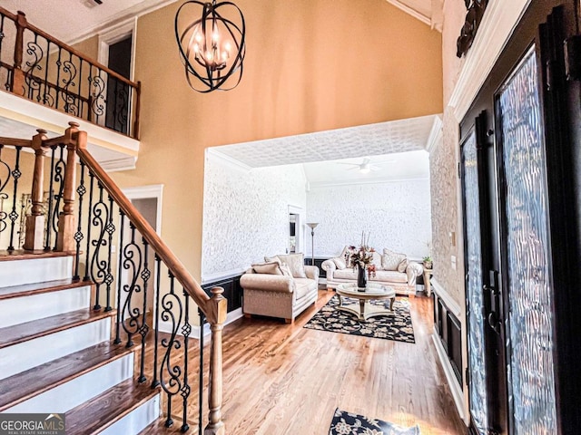 2319 Lochinver Ln SW, Conyers, GA 30094 - foyer with crown molding, wood finished floors, stairs, ceiling fan, and a chandelier