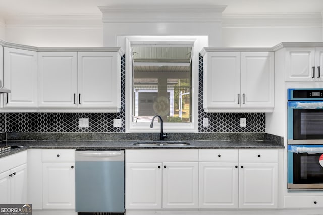kitchen featuring crown molding, white cabinets, stainless steel double oven, dishwashing machine, and a sink