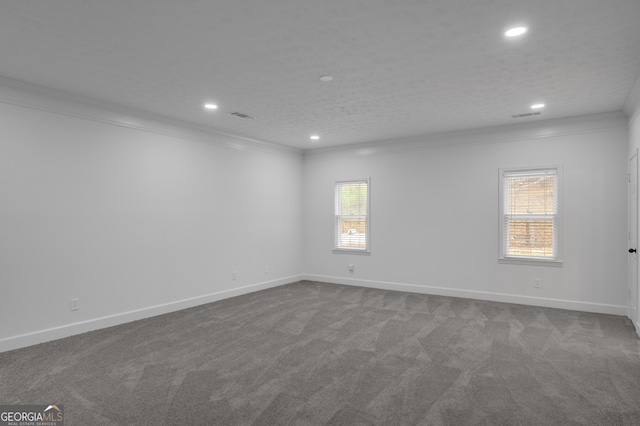 unfurnished room featuring recessed lighting, visible vents, crown molding, and dark carpet