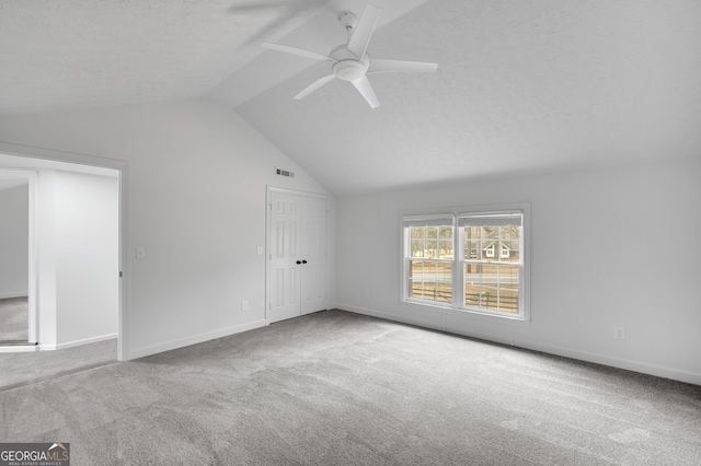 interior space with baseboards, vaulted ceiling, and carpet floors
