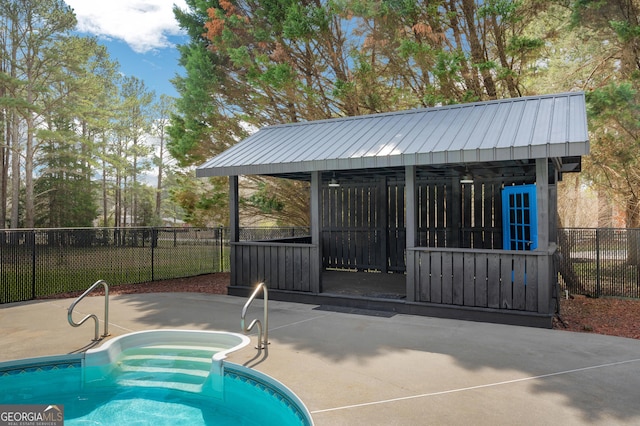 view of pool with a fenced in pool, a patio, an exterior structure, an outbuilding, and fence