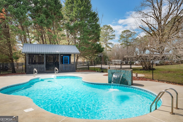 view of swimming pool with an exterior structure, fence, an outdoor structure, a patio, and a fenced in pool